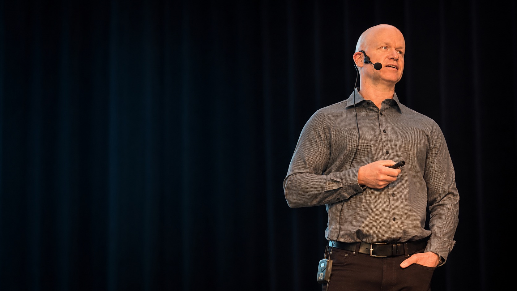 Janne Ikola speaking on stage